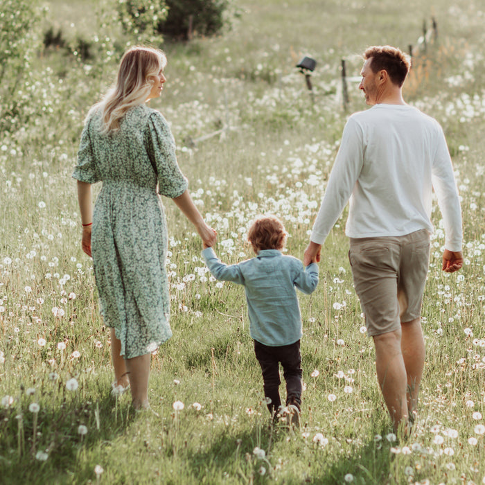 Famille main dans la main dans un champs